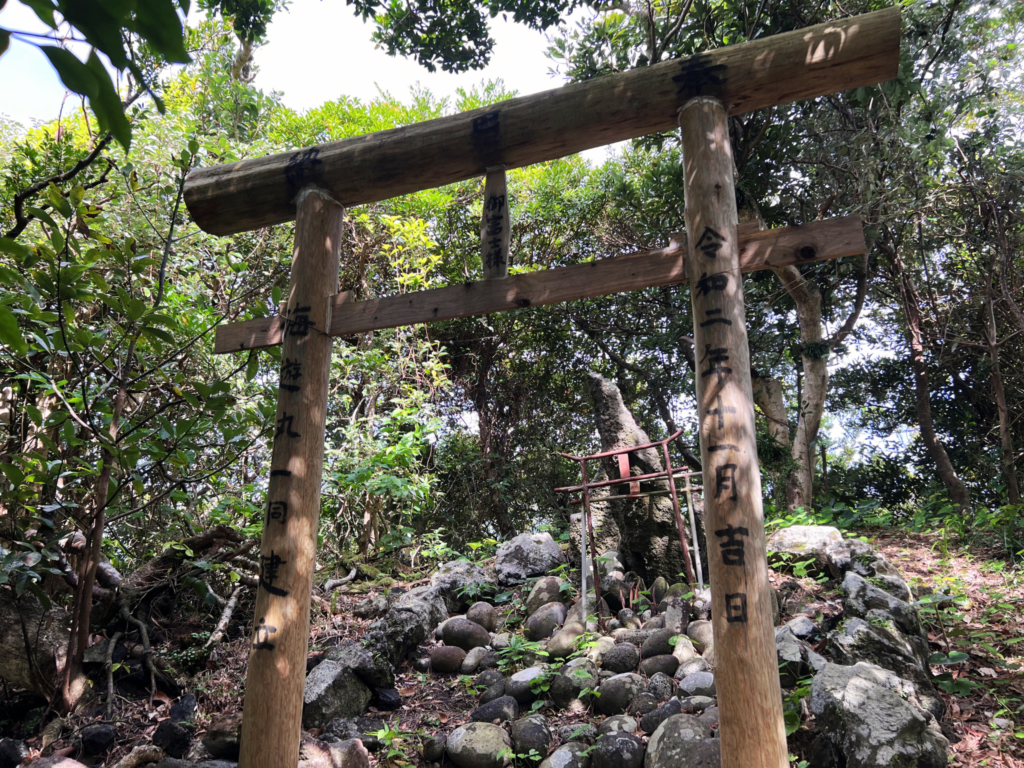 Ancient stone Torii gate hidden in the lush jungle of Aogashima island