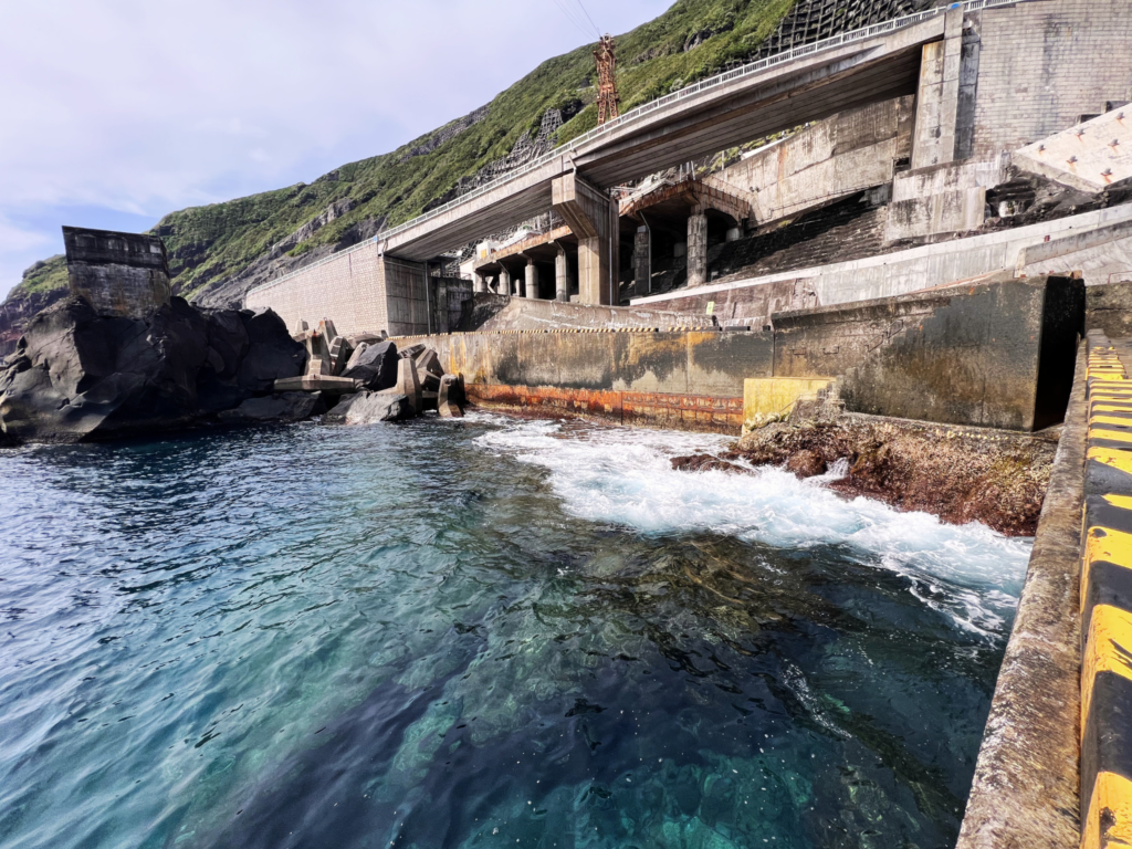 Rough waves hitting the concrete structures at Sanpo Port in Aogashima island